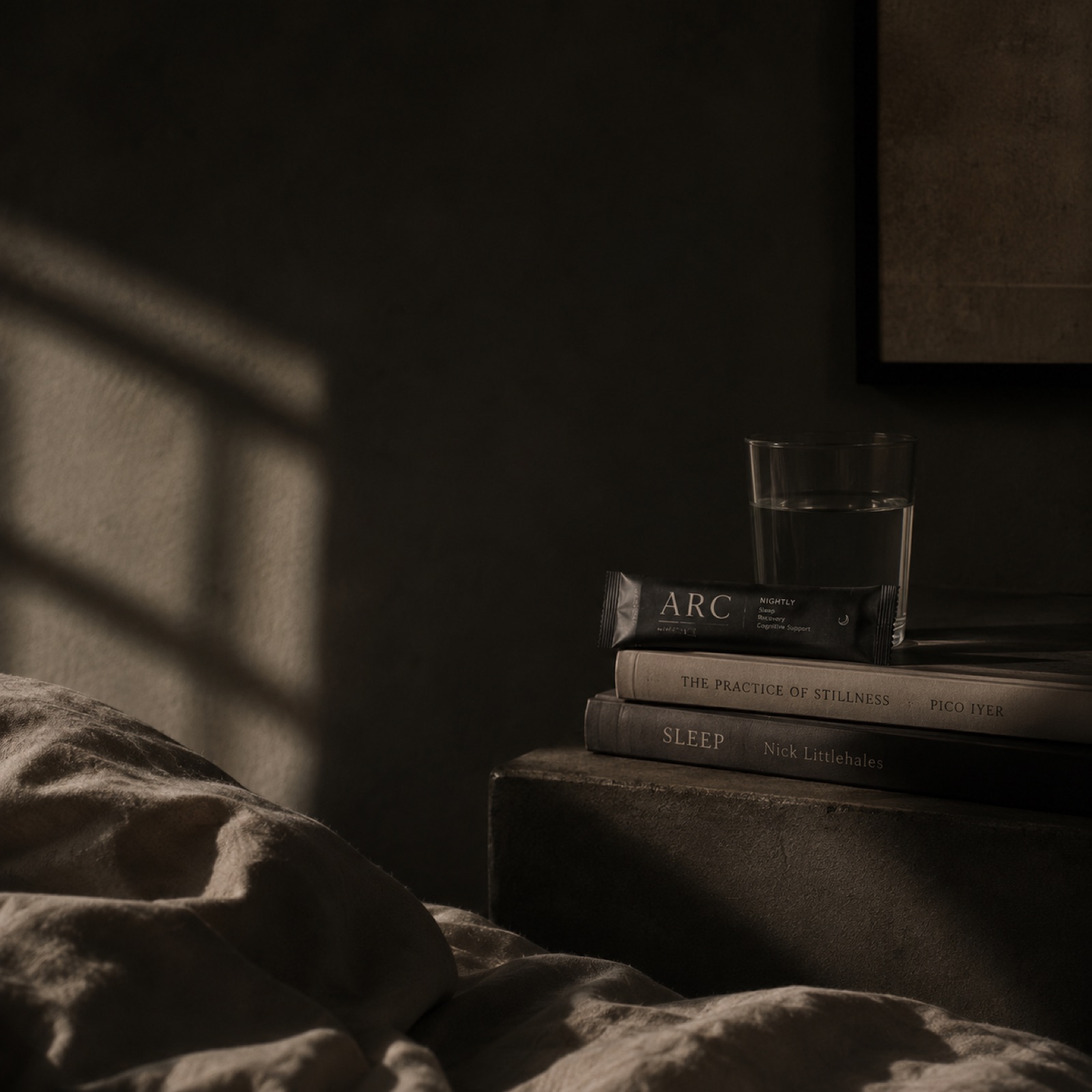 The Long Arc — Episode 01 cover. A glass of water and ARC books on a bedside in late shadow