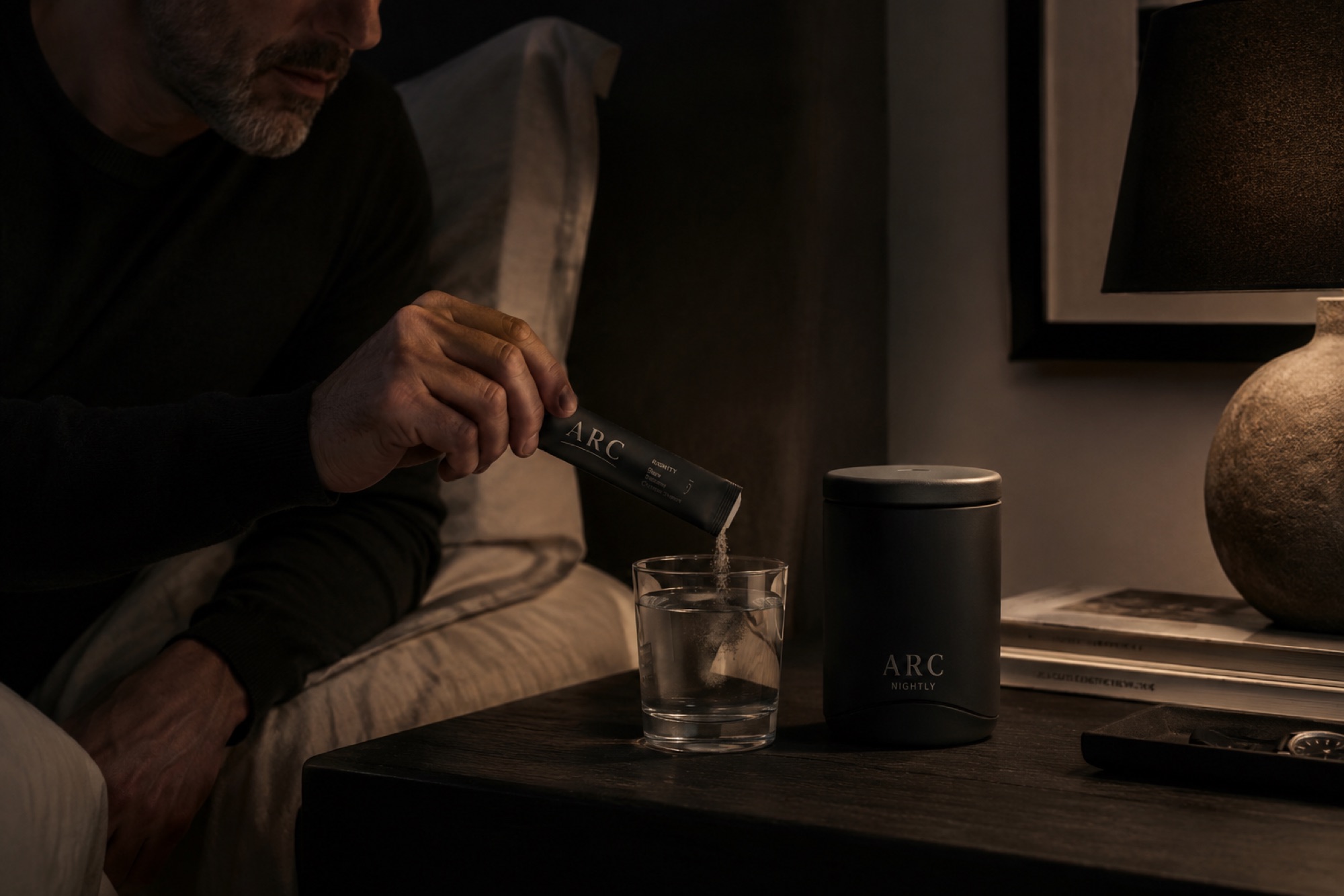 The nightly ritual — pouring a stick into a glass of water at the end of the day, late warm light, the ceramic vessel on the nightstand